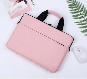 Pink laptop bag with black handles showing front zipper pocket on a white office desk