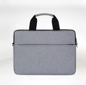 Front view showing the durable grey fabric texture and dual zipper design of the laptop bag