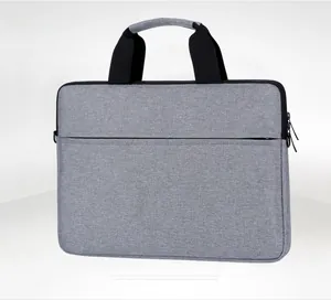Detailed side view of light gray laptop bag featuring thick black handle and zipper pocket
