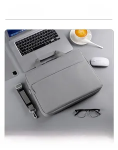 Detail of gray business laptop bag with reinforced handles and removable shoulder strap