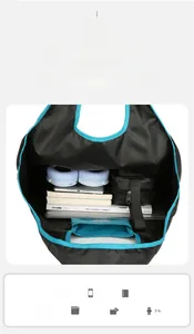 Interior view of black travel bag with blue lining showing spacious capacity and pockets