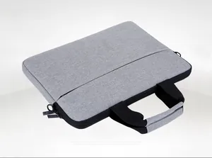 Flat lay view of a grey waterproof Oxford fabric laptop bag with black padded handles