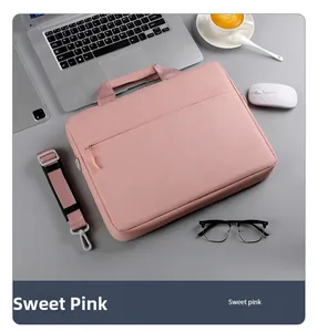 Flat lay of sweet pink laptop bag with shoulder strap and business workstation accessories
