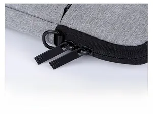 Detail of durable water-resistant fabric with matte black dual metal zippers and D-ring