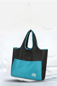 Macro detail of lightweight foldable travel tote showing VANAHEIMR logo and waterproof nylon
