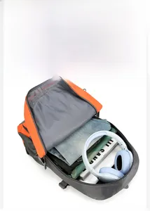 Spacious main compartment of orange hiking backpack showing clothes and headphones inside