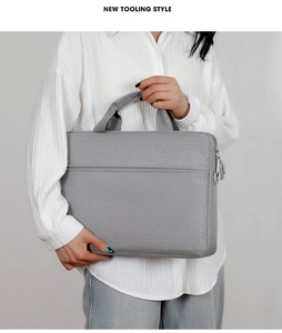 Detail of gray laptop briefcase with reinforced handle and large front pocket