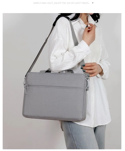 Detail view of gray laptop bag showing durable fabric, handles and shoulder strap