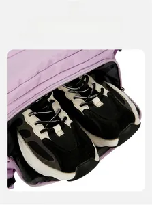 Detail of a purple travel backpack featuring a separate bottom compartment for shoes
