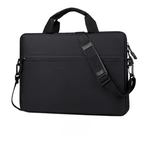 Detail of black business laptop bag showing reinforced handles and detachable shoulder strap