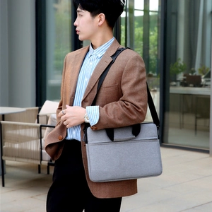 Grey minimalist business laptop bag with adjustable shoulder strap and hidden pocket