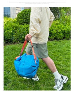 Detail of blue waterproof backpack with orange straps for outdoor hiking and travel use