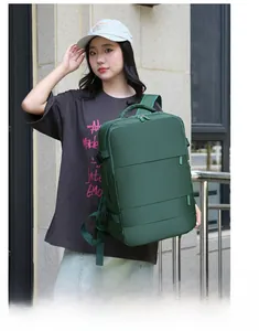 Outdoor shot of a dark green travel backpack with multiple compartments and side straps