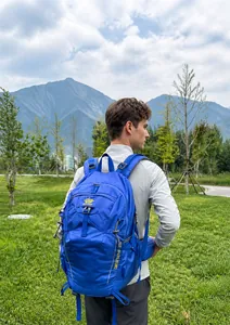 Blue hiking backpack featuring ergonomic straps and adjustable chest buckles in nature