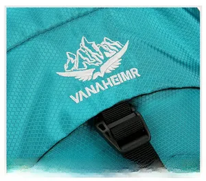 Detail of embroidered mountain logo on durable blue ripstop nylon hiking backpack