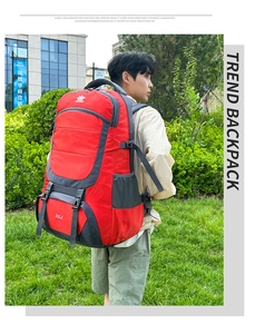 Outdoor 85L hiking backpack in red and grey shown on model for size perspective
