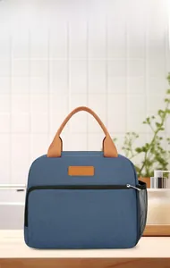 Detail of insulated lunch bag featuring durable handles and functional side mesh pocket