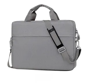 Gray business laptop bag with dual handles and padded adjustable shoulder strap