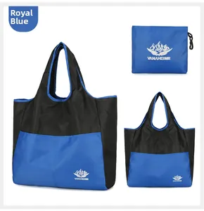 Detail of royal blue foldable travel bag with storage pouch and water-resistant fabric