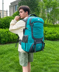 Detailed side view of 85L green outdoor hiking backpack on male model in nature