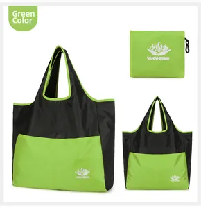 Detail view of foldable green nylon travel bag with branded storage pouch and mountain logo