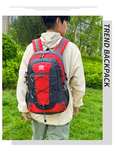 Outdoor hiking backpack with red and black nylon fabric, bungee cords and mesh pockets