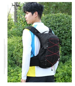 Detail of waterproof hiking backpack with red bungee cords and breathable mesh straps