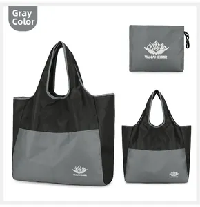 Foldable gray travel bag made of waterproof nylon with a matching drawstring storage pouch