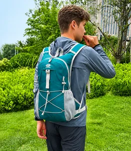 Detail of teal lightweight cycling backpack with bungee cord system and mesh side pockets