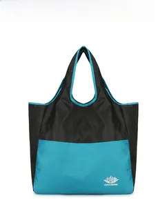Front view of a foldable travel bag with blue and black paneling and mountain logo