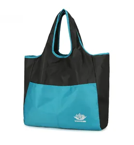 Detail of waterproof ripstop fabric and VANAHEIMR logo on the black and blue travel bag