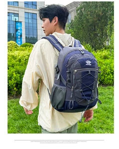 Detail view of large outdoor backpack with mountain logo and bungee cord system