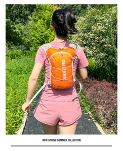 Detail of breathable grey mesh shoulder straps on the lightweight orange hydration pack