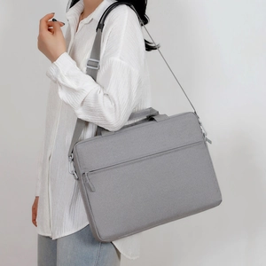Minimalist grey fabric business laptop bag with adjustable shoulder strap and side view