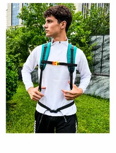 Close-up of hiking backpack breathable mesh straps with orange chest buckle and waist belt