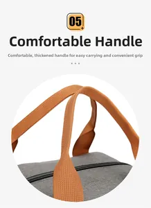 Close-up of reinforced orange woven handles on a gray insulated waterproof lunch bag