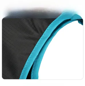 Detail showing high-density black textured fabric with blue reinforced stitching and piping