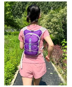 Rear view of a runner wearing a lightweight purple hydration vest for trail running and hiking