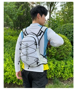 Detail of white trekking backpack showing elastic bungee cord and breathable mesh shoulder straps