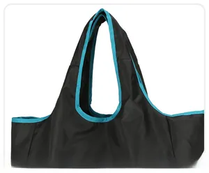 Detail of reinforced wide handle with blue piping on black foldable travel tote bag