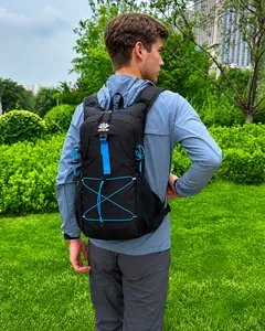 Ergonomic black outdoor cycling backpack with blue elastic straps shown in outdoor use