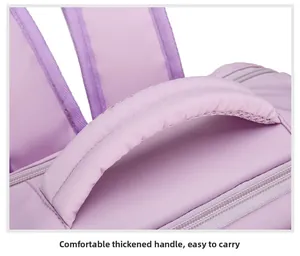 Detail of a purple backpack featuring a comfortable thickened handle for easy carrying