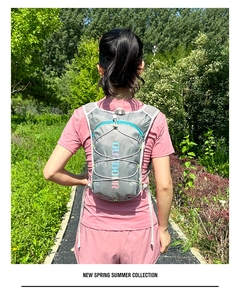 Grey lightweight hydration backpack with elastic cords and vertical OUTDOOR logo print
