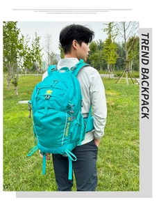 Detail view of 36L teal hiking backpack with ergonomic straps shown on male model outdoors