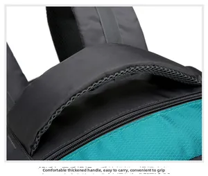 Close-up of padded top handle and durable ripstop fabric on a hiking backpack