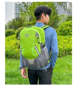 Detailed outdoor view of a green hiking backpack with trekking pole hooks and mesh pockets