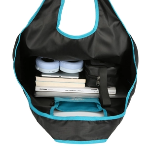 Large capacity folding travel tote in black nylon with blue trim and interior storage bag