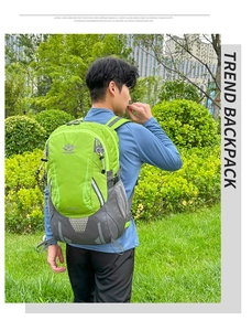 Detail of 35L outdoor hiking backpack in green and gray with reflective strips