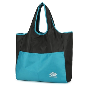Foldable nylon travel tote bag in black and blue color block with Vanaheimr logo
