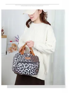 Detail of leopard print insulated lunch bag with mesh side pocket and zipper closure